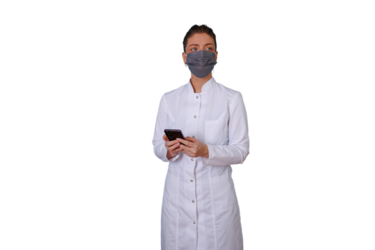 Woman doctor wearing face mask, using smartphone in lab coat, showing healthcare communication technology - Powered by Adobe