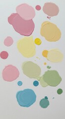 Assortment of colorful, thick paint dabs scattered across a bright white background surface