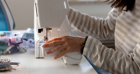 Woman Adjusting Sewing Machine