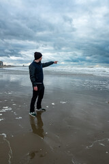solitary individual watches storm approach, isolated figure gazes at approaching tempest