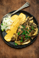 Polenta with porcini mushrooms. Traditional Lombardy cuisine, Italian cuisine