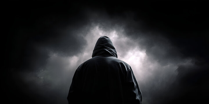 Lone hooded person under ominous cloudy sky