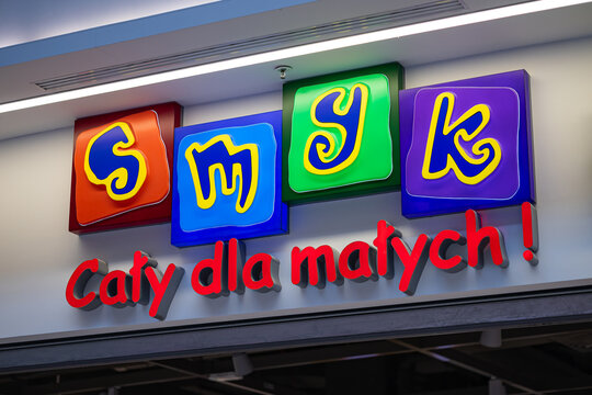 Wroclaw, Poland- October 25, 2025: Colorful illuminated sign of Smyk children's store with bright playful letters and slogan above the entrance in modern shopping mall. Kids fashion and toys