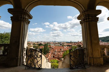 Fototapeten Prag Prague, Czech Republic – August 6, 2025: View from the terrace of the Palace Gardens below Prague Castle, overlooking the red rooftops of Malá Strana, Prague, on a summer day.  © Vidu Gunaratna