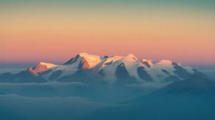 Snow capped mountain range bathed in golden hour light above clouds peak summit