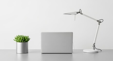 Minimalist Workspace Laptop, Desk Lamp, and Succulent on White Desk