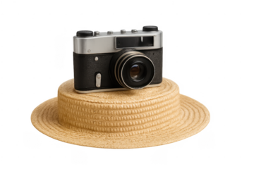 Vintage camera on straw boater hat symbolizing travel