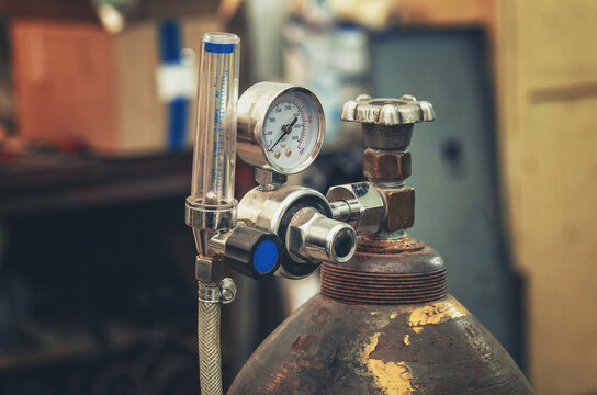 Gas cylinder pressure gauge. Cylinder with compressed gas oxygen for welding. Technological photo.