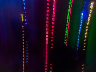 Elegant neon colored lines of light cut through the darkness of the night, giving a futuristic and dynamic impression of speed and movement, like a stunning digital abstract painting