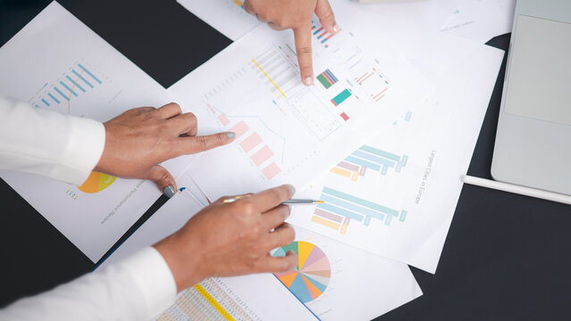 Business team analyzing financial report and marketing data chart for strategy planning - Powered by Adobe