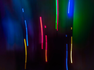 Elegant neon colored lines of light cut through the darkness of the night, giving a futuristic and dynamic impression of speed and movement, like a stunning digital abstract painting