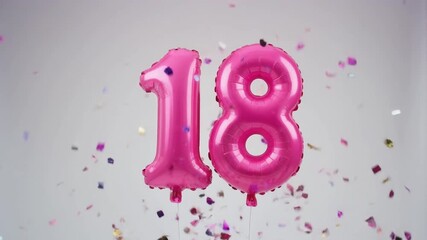Pink balloon number 18 for birthday or anniversary party. White background with falling confetti