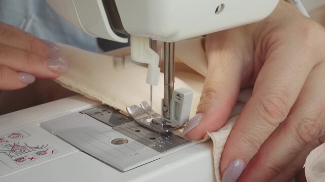 senior woman tailor sewing clothes using sewing machine, process of creating dress. Close-up hands seamstress's fabric stitching. female fashion designer work. elderly lady hobby home workshop space - Powered by Adobe