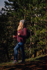 Woman hiking enjoying sunshine in lush forest