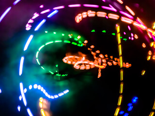 Colorful light particles form digital curves and dots in a light painting effect, creating an energetic and futuristic background.