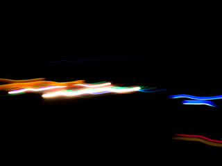 Elegant neon colored lines of light cut through the darkness of the night, giving a futuristic and dynamic impression of speed and movement, like a stunning digital abstract painting