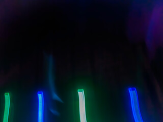 Elegant neon colored lines of light cut through the darkness of the night, giving a futuristic and dynamic impression of speed and movement, like a stunning digital abstract painting