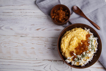 banosh, polenta with cracklings and brynza in a clay bowl. Copy space.