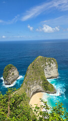 promontory overlook with twin islets, secluded tropical cove Nusa Penida Kelingking Beach Bali 