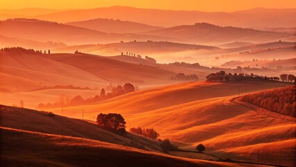 Golden sunrise light over rolling tuscan hills with morning mist