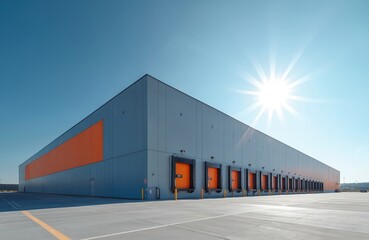 Modern industrial warehouse exterior features loading docks under bright sun, blue sky. Large scale logistics building facade grey metal panels, orange accent wall. Business complex provides goods