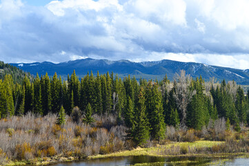 Grand Teton Mountain's featuring a Forest and River view
