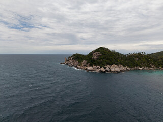 colorful beachfront with bustling markets, energetic coastal village filled with palms and boats Koh Tao Thailand