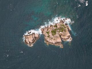 secluded island retreat, serene rocky island scene, peaceful islet surrounded by vibrant blue waters Koh Tao Thailand