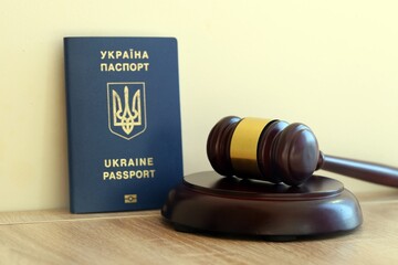 Judge mallet and ukrainian passport on brown background. Passport Of Ukraine. Obtain citizenship