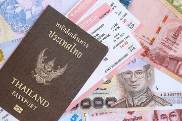Thai baht currency money bills with tickets and passport close up. The concept of travel and vacation