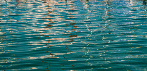 Reflections on the water created of boats