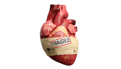 A realistic depiction of a human heart, wrapped with tape that reads "FRAGILE