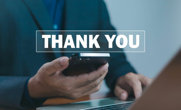 Businessman holding smartphone and working on laptop with thank you message overlay, symbolizing digital communication, appreciation, and online business connection in modern corporate lifestyle.