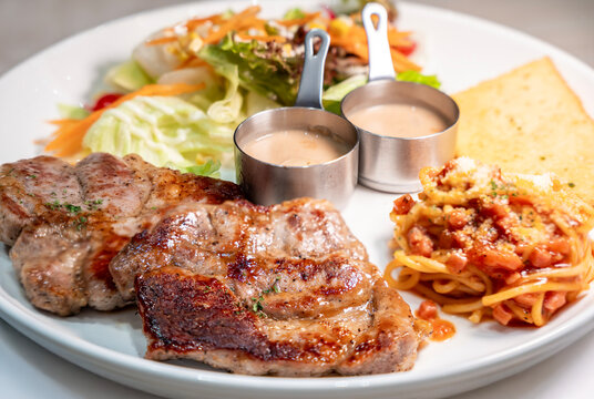 Grill chicken and pork pepper served with fresh salad, truffle souce, garlic toast and spaghetti.