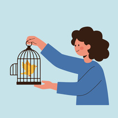 A person with dark curly hair holding a birdcage containing a yellow bird against a pale blue backdrop