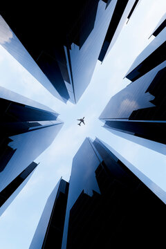 Airplane framed by 3D buildings from street level view