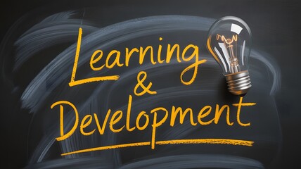 Learning and Development Concept with Idea Lightbulb on Blackboard