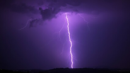 Dramatic purple lightning illuminating a stormy night sky, capturing raw natural energy.