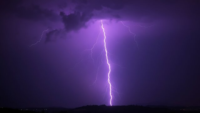 Dramatic purple lightning illuminating a stormy night sky, capturing raw natural energy.