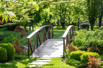 Wooden bridge against greenery in sunlit park outdoors Core Cider in Perth