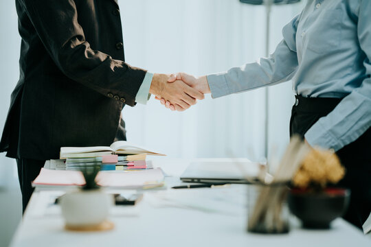 Deal Agreed: Two business partners seal a partnership with a firm handshake, symbolizing trust, collaboration, and a shared vision of success.
