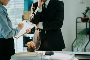 Business Conversation: A focused business professional engaged in a deep conversation with a colleague, the atmosphere suggests a critical discussion or decision-making process.