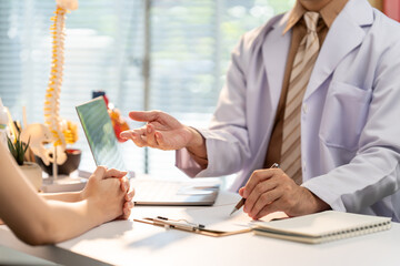 Medical Consultation: A doctor is having a detailed conversation with a patient during a consultation, providing healthcare service.