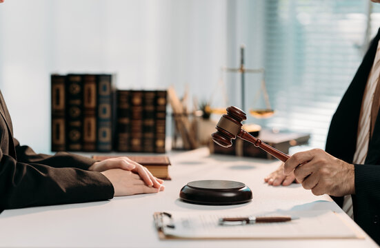 Legal Proceedings: A close-up view capturing the solemnity of a legal setting, where justice unfolds with a gavel symbolizing the final say.