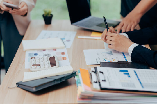 Strategic Synergy: An ensemble of dedicated professionals collaborating to analyze financial reports and devise a robust business strategy, the scene captures the essence of diligent teamwork.