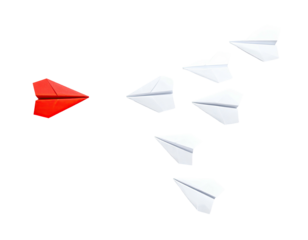A red paper airplane leading a formation of white ones on a solid black backdrop