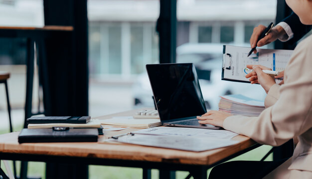 Business Collaboration and Analysis: A focused team engages in collaborative analysis, discussing strategies and insights in a modern workspace environment, fostering innovation and teamwork.