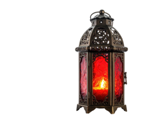 Decorative, ornate, antique lantern with red glass, lit candle, and metallic framing, dark backdrop