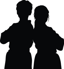 Silhouette of two children standing back to back wearing martial arts uniforms with arms crossed