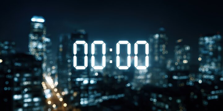 Digital timer reads midnight against a city skyline illuminated by lights on a clear night